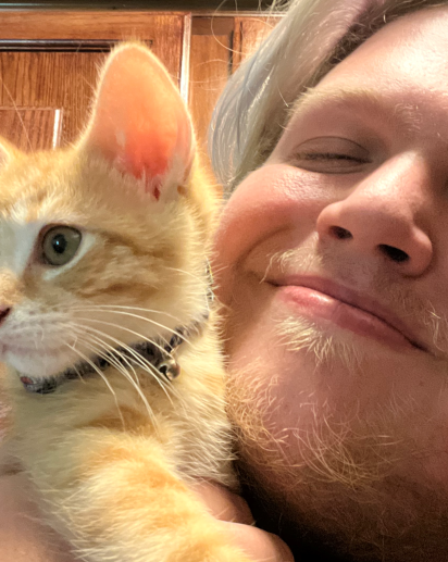 Kai Herron profile picture with kitten